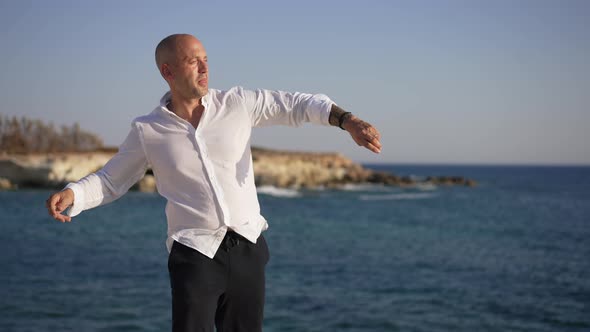 Side View Confident Man Throwing Stone in Dark Blue Mediterranean Sea Water in Slow Motion