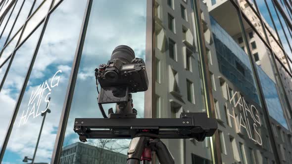 Low Angle Of Camera Slider Shooting Timelapse Footage In Oslo, Norway With Vaaghals Building In Back