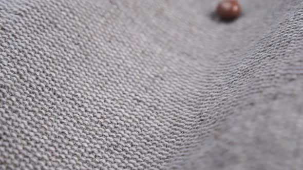 Chocolate glazed nut candies falling on a rustic jute cloth in slow motion. Close up