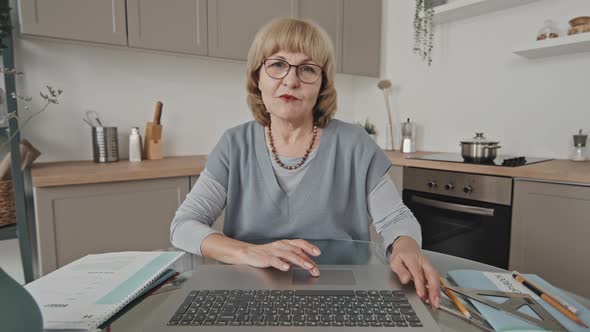 POV of Senior Teacher Talking on Video Call on Laptop