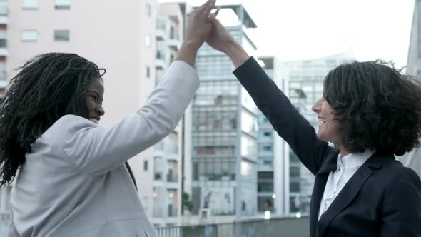 Successful Businesswomen Giving High Five on Street.