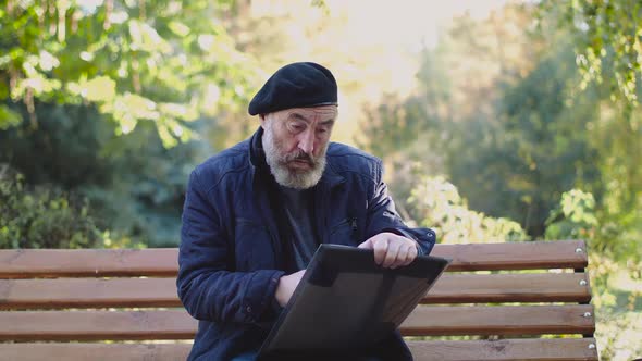 Lonely Artist Sitting on Street Bench and Drawing with Emotions