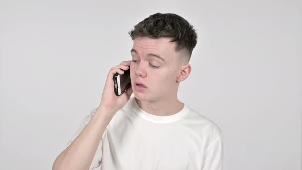 Young Man Talking on Smartphone on White Background