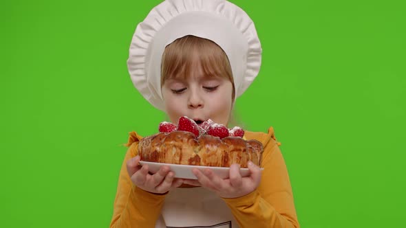 Child Girl Kid Dressed As Cook Chef Sprinkle Strawberry Cake with Icing Sugar Chroma Key Background