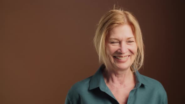 Studio Portrait of Cheerful Senior Lady