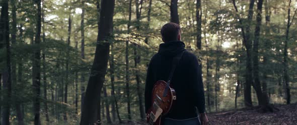 Guitar Player in the Woods