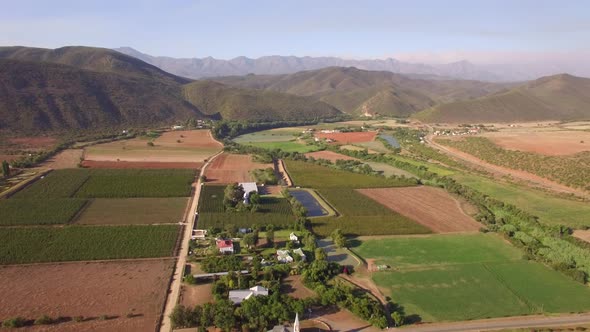 Aerial travel drone view of farms and farming.