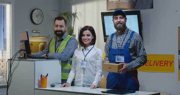 Delivery Center Employees Standing By Desk