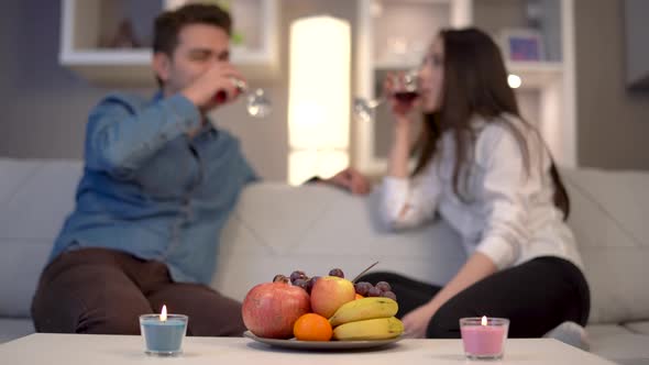 Couple drinking wine chatting.