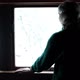 An Elderly Woman Stands By the Window and Turns to the Camera - VideoHive Item for Sale