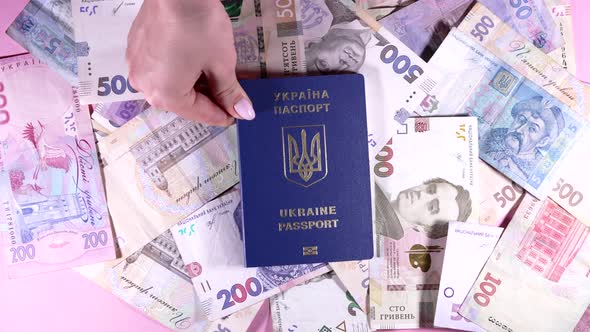 Woman Puts Ukrainian International Passport on Money Pile of Hryvnias