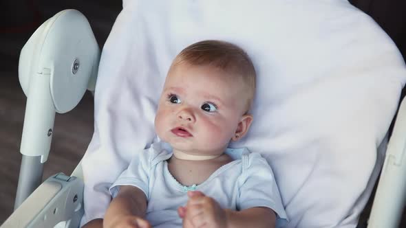 Cute Little Newborn Girl with Smiling Face Looking at Camera on White Background