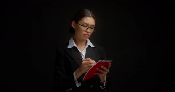 Business Lady Does Not Like What is Written in Notebook She Tears Out a Sheet