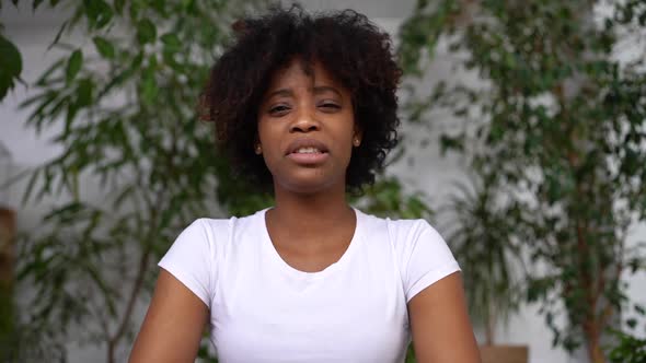 Portrait of Confident Mixed Race Business Woman Talking to Camera at Work By Videocall Conference