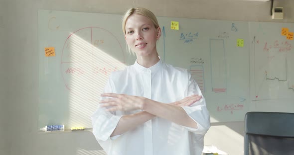 Portrait of the Successful Hispanic Businesswoman Crossing Her Arms and Smiling