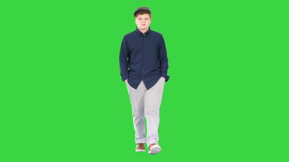 Fashionable Young Man Walking with Hands in Pockets on a Green Screen, Chroma Key