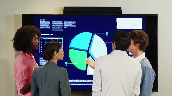 Businesspeople interacting over a pie chart