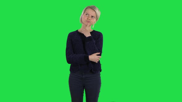 Blonde Girl with Creative Haircut Is Thinking on a Green Screen