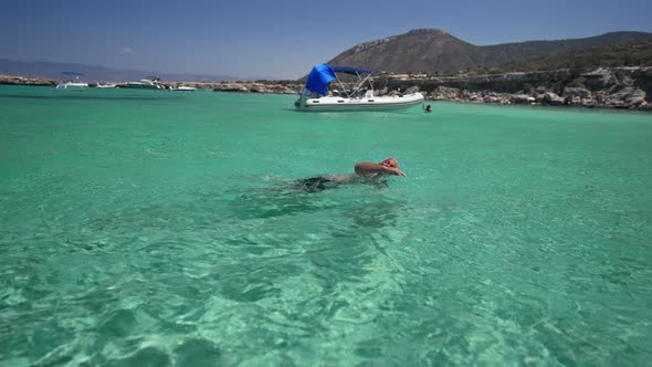 Side View Confident Tattooed Caucasian Tanned Man Swimming in Transparent Turquoise Mediterranean