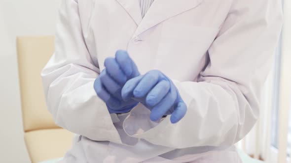 Doctor Wears Special Disposable Sterile Gloves