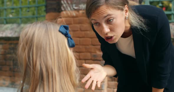 Close Up View of Mother Child Conflict, Young Angry Woman Yelling at Her Schoolgirl Daughter