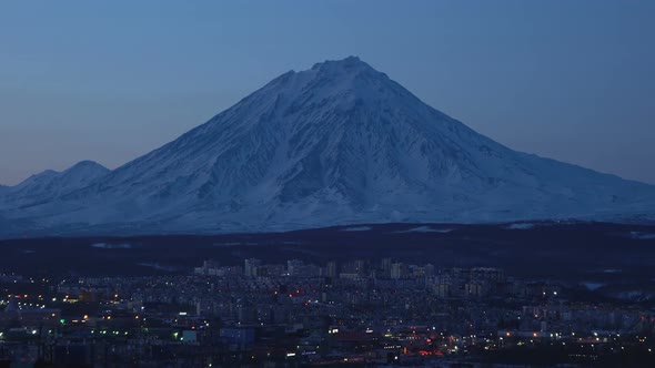 Night View of Cityscape of Petropavlovsk-Kamchatsky City on Background Cone of Volcano