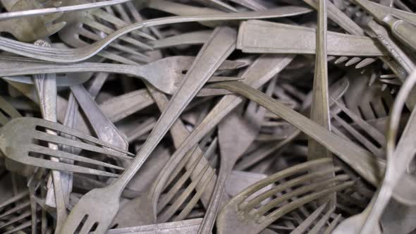 Vintage forks, kitchen cutlery close up, old tarnish covered flatware background