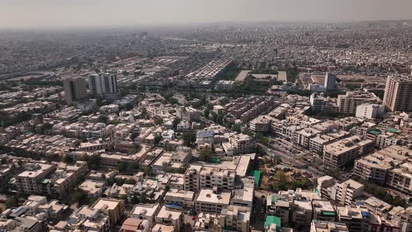 Drone Flying Over Karachi City Skyline In Pakistan With Haze Seen In The Distance. Circle Dolly
