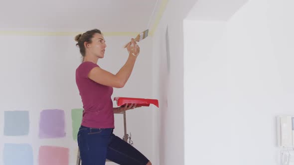 Portrait of a Caucasian woman in quarantine during coronavirus pandemic, doing interior work