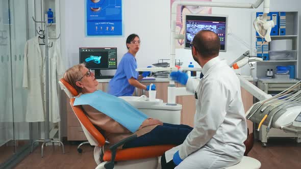 Doctor Discussing a Plan for Denture Recovery Looking at x Ray