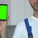 Attractive repairman demonstrating greenscreen smartphone to camera - VideoHive Item for Sale