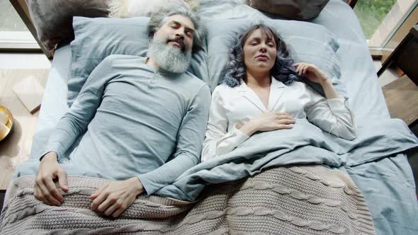 Sleeping Man and Woman Waking Up in Bed at Home and Leaving Bedroom in Hurry Being Late for Work