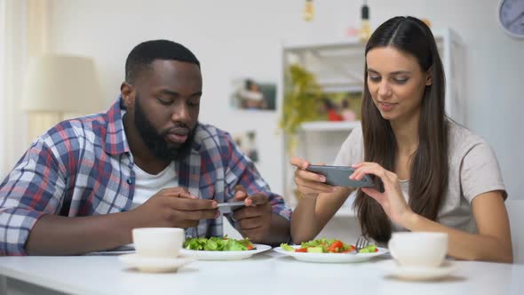 Mixed-Race Couple Making Photos of Salad, Posting in Social Networks, Food Blog