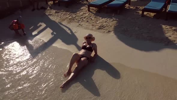 Woman in Hat on the Beach