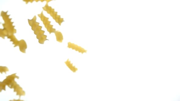Pasta Fusili Flying Diagonally on a White Background in Super Slow Motion