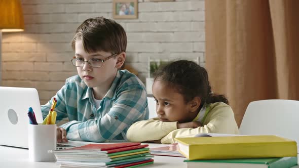 Boy and Girl Watching Movie on Laptop