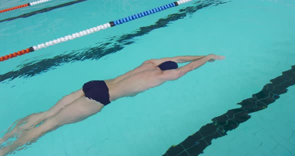 Swimmer swimming into the pool