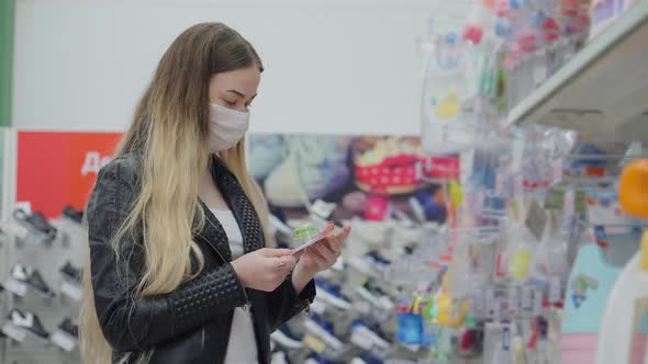 Woman with Mask is Shopping in Child Goods Department