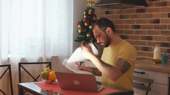 Hardworking Man with Laptop at Home