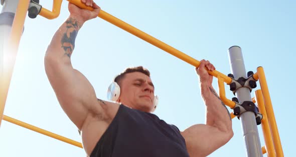 Portrait of Male Athlete Doing Exercises Outdoors in Summer