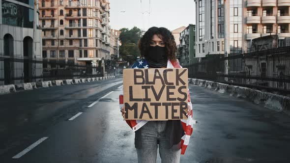 Africanamerican Girl in Black Bandana Wrapped in Flag of USA