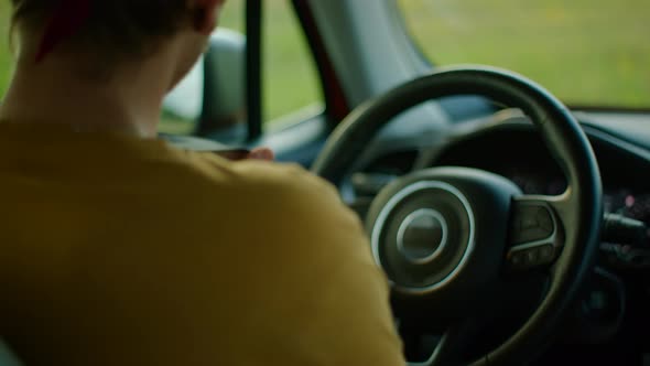 Young Man Gets Into the Car Fastens Seat Belt Getting Ready to Drive and Travel