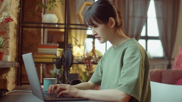 Asian Woman Using Laptop at Home