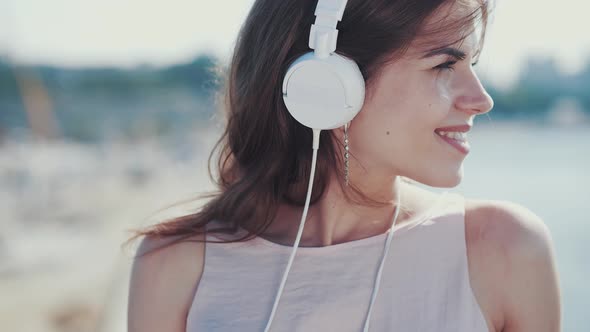 A young girl listens to music