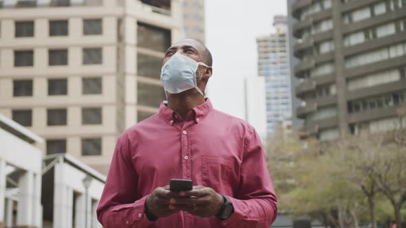 African american man on the go wearing coronavirus covid19 mask