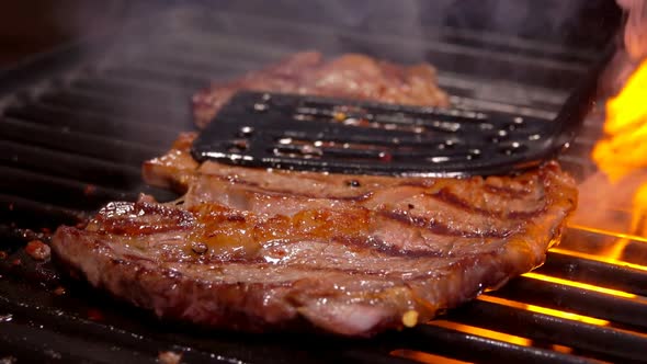 Spatula Presses the Steak on the Hot Surface