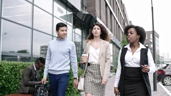 Diverse Business Partners Chatting and Walking in Downtown