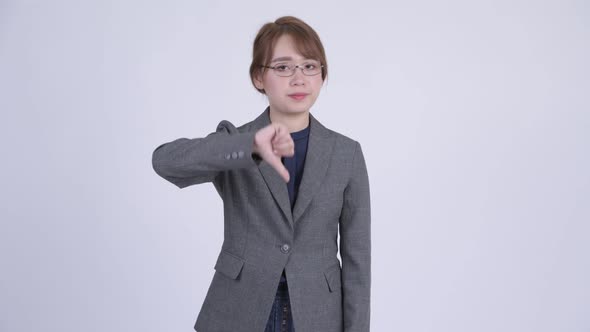 Young Angry Asian Businesswoman Giving Thumbs Down