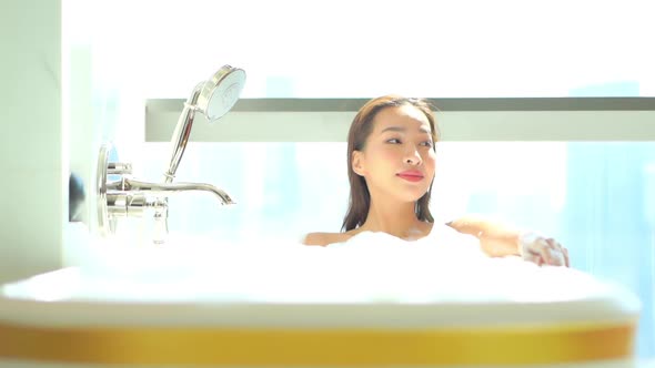 Young asian woman relax in bathtub