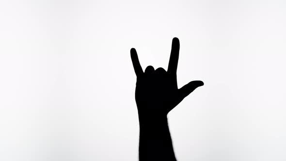 Man Showing Rock and Roll Gesture with Fingers Isolated on White Background